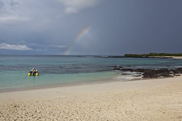 Rainbow over the sea off the coast of the Galapagos Islands, Las Bachas beach